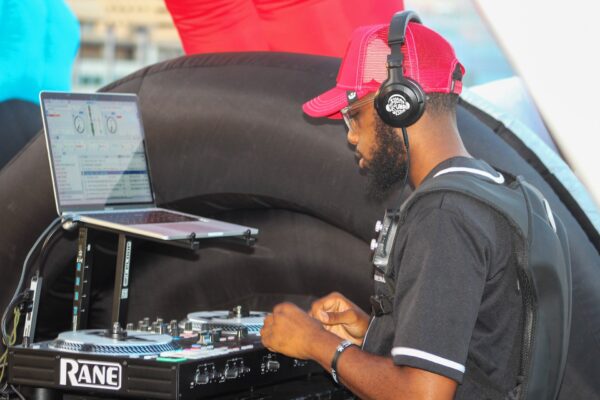 A DJ on his laptop wearing HiFi Headphones