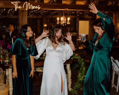 A bride dances with her bridesmaids at a wedding wearing Silent Sound System headphones